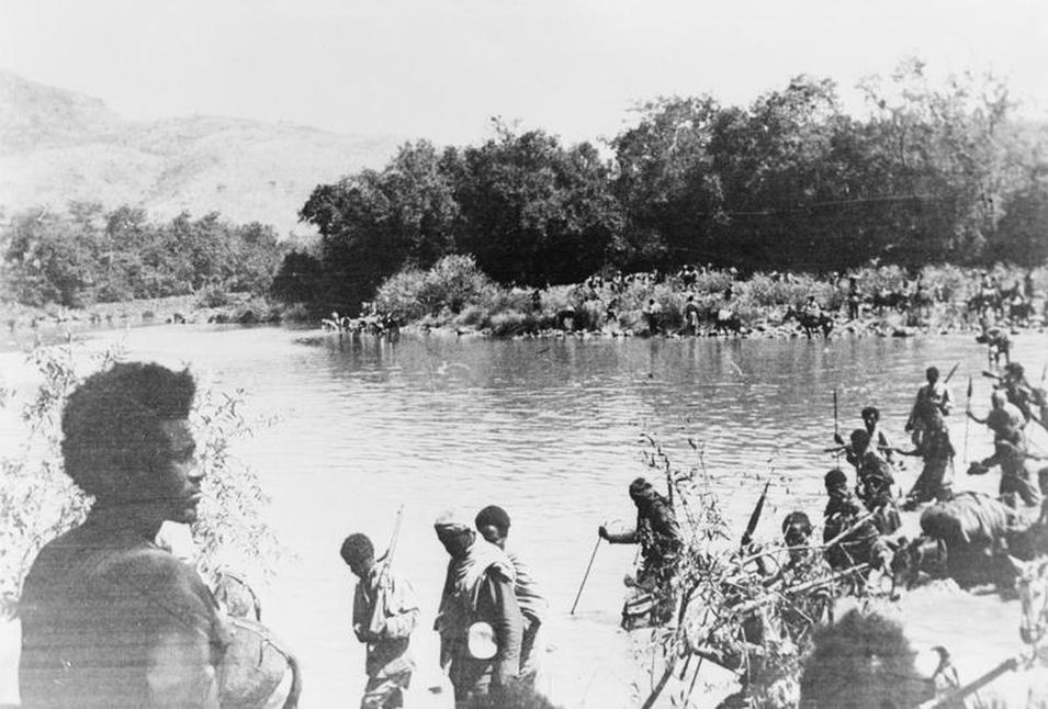 In magnificent silhouette, Dej. Geresu Duki watches his army cross the Omo river into Italian territory (circa 1936-1941)